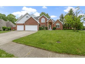 Beautiful brick two-story home featuring an attached two-car garage and a well-manicured lawn at 8723 Bergeson Dr, Indianapolis, IN 46278