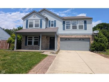 Charming two-story home featuring a covered front porch and two car garage on a sunny day at 9206 Huntleigh Cir, Plainfield, IN 46168