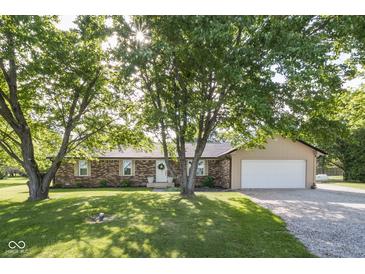 Charming brick ranch home with mature trees, well-manicured lawn and two car garage at 9390 N State Road 39, Lizton, IN 46149