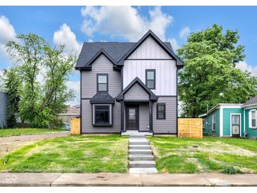 Charming two-story home with a beautifully landscaped yard and inviting exterior, perfect for modern living at 1027 Hosbrook St, Indianapolis, IN 46203
