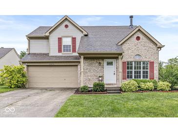 Charming two-story home with a combination of vinyl siding and brick, red shutters, and a well-maintained front yard at 11072 Lake Run Dr, Fishers, IN 46038