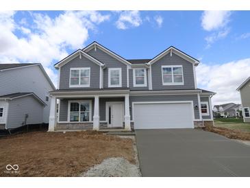 Charming two-story home featuring gray siding, a two-car garage, and a welcoming front porch at 12403 Fresh Stock Dr, Noblesville, IN 46060