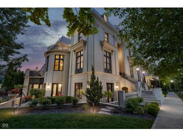 A luxurious home boasts manicured gardens and a charming outdoor design at 1894 Rhettsbury St, Carmel, IN 46032