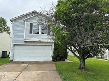 Charming two-story home with vinyl siding, a white garage door, and a well-maintained lawn at 4456 Redcliff N Ln, Plainfield, IN 46168