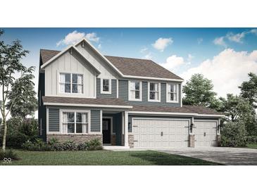 Charming two-story home with a three-car garage, a covered entry and nicely landscaped yard at 8853 Alexander Ridge Dr, McCordsville, IN 46055