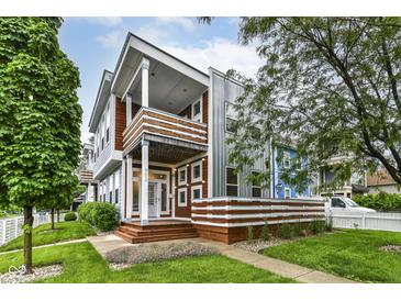 Striking two-story townhouse showcasing modern architecture and well-maintained landscaping at 902 Woodlawn Ave, Indianapolis, IN 46203