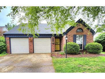 Charming single-story brick home featuring a two-car garage and well-maintained landscaping at 9507 Colony Pointe E Dr, Indianapolis, IN 46250