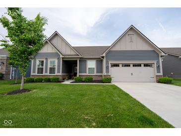 Charming single-story home featuring a well-manicured lawn, inviting curb appeal, and a two-car garage at 9741 Haughton Ln, McCordsville, IN 46055