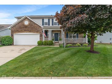 Charming two-story home with brick accents, covered porch, landscaped yard, and attached two-car garage at 9756 Brook Meadow Dr, McCordsville, IN 46055
