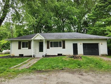 Charming single-story home with a well-maintained yard, front porch, and attached one-car garage at 988 Westfield Rd, Noblesville, IN 46062