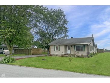 Charming single story home featuring a lush lawn and matching shutters at 108 N A St, Elwood, IN 46036