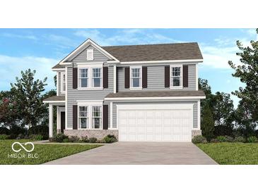 Charming two-story home boasts gray siding, brick accents, a two-car garage, and well-manicured landscaping at 1108 Bevy Blvd, Danville, IN 46122