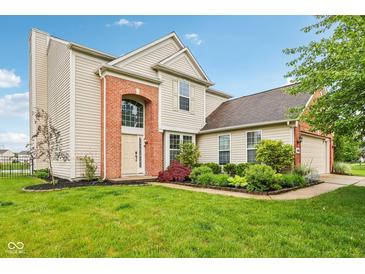 Charming two-story home featuring a manicured lawn and brick accents at 14036 Rayners Ln, Fishers, IN 46037