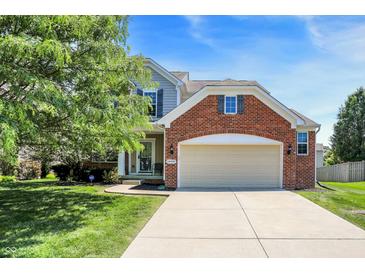 Charming two-story home with a brick facade and well-manicured lawn at 14499 Milton Rd, Fishers, IN 46037