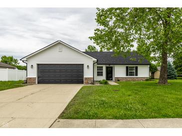 Charming single-story home with a dark garage door and well-maintained front yard at 321 Virginia St, Fortville, IN 46040