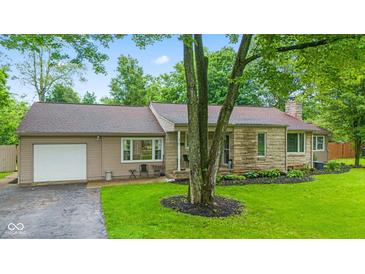 Charming one-story home with stone accents, attached garage, and well-maintained front yard at 426 Tipton Ln, Columbus, IN 47201