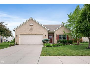 Charming brick home featuring a well-manicured lawn, attached two car garage, and a welcoming front entrance at 5576 W Glenview Dr, McCordsville, IN 46055