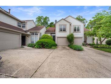 Charming townhome featuring an attached two-car garage, well-maintained landscaping, and a cozy, inviting facade at 6263 Behner Way, Indianapolis, IN 46250