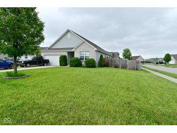Charming single-story home with a well-maintained lawn, truck in driveway, and attractive landscaping at 7515 Brattle Dr, Indianapolis, IN 46113