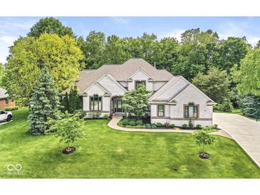 Beautifully landscaped two-story home with manicured lawn, mature trees, and brick facade at 790 Foxboro Dr, Avon, IN 46123