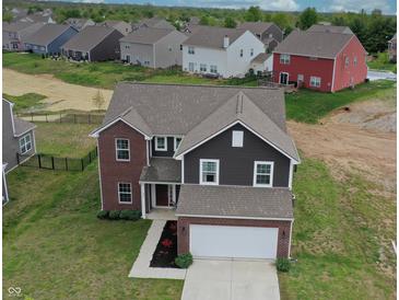 Beautiful home with a brick and siding exterior, well-manicured lawn, and a two-car garage at 808 Capricorn Dr, Franklin, IN 46131