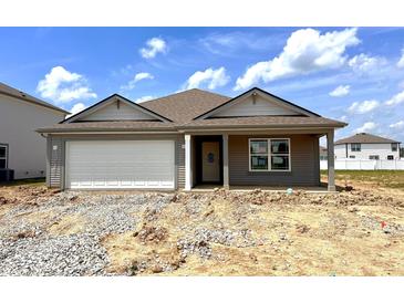 Charming single-story home featuring a two-car garage and classic neutral color siding at 1170 Mcbride St, Greenfield, IN 46140