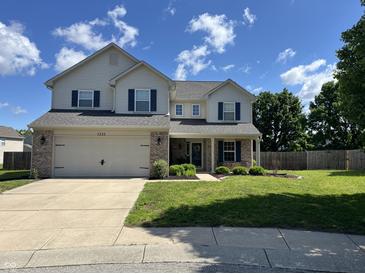 Charming two-story home with a well-manicured lawn and a two car garage at 1222 Grand Canyon Ct, Franklin, IN 46131