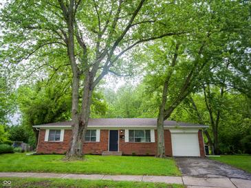 Charming brick home with mature trees providing shade and curb appeal at 21 Roderick Ct, Beech Grove, IN 46107