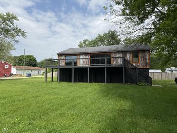 Charming home with a black foundation, and wooden deck overlooking a lush green yard at 258 Riverwood Dr, Noblesville, IN 46062