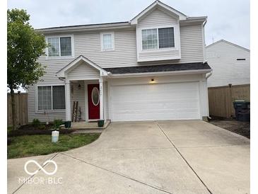 Two-story home with neutral siding, a red front door, and an attached two-car garage at 2637 Grand Fir Dr, Greenwood, IN 46143