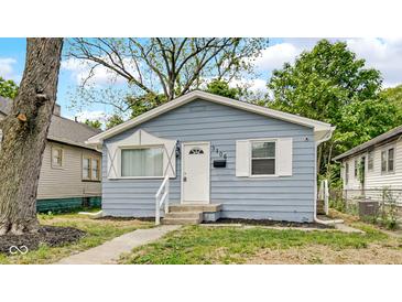 Charming blue house featuring a white front door and well-maintained landscaping at 3106 N Harding St, Indianapolis, IN 46208