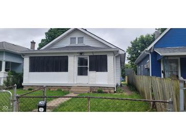 Charming home featuring white paint, a small front porch, and a fenced yard, ideal for first-time buyers at 427 N Alton Ave, Indianapolis, IN 46222