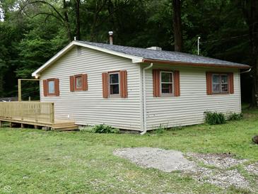 Charming home featuring lap siding, complemented by a wooden deck, and surrounded by lush green trees at 4675 N Herbemont Rd, Martinsville, IN 46151
