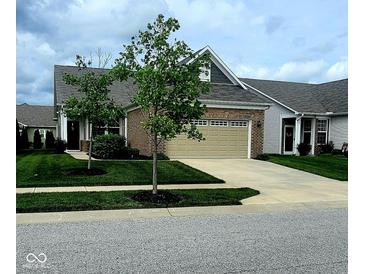 Charming single-Gathering home featuring a brick facade, attached two-car garage, and a well-manicured lawn at 4960 Silverbell Dr, Plainfield, IN 46168