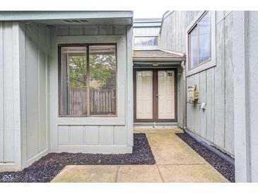 Inviting entrance with double doors, window, and black mulch landscaping at 5097 Vantage Point Rd # B 2, Avon, IN 46123