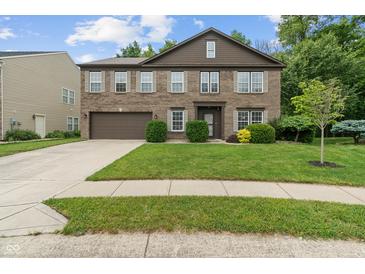Traditional two-story brick home with a well-maintained lawn and attached two car garage at 5640 High Vista Cir, Indianapolis, IN 46234