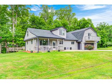 Charming home exterior with a well-maintained lawn, lush landscaping, and a two-story design at 5739 Paradise Dr, Martinsville, IN 46151