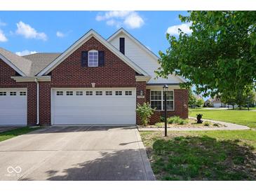 Charming brick home featuring a manicured lawn, a two-car garage, and tasteful landscaping at 6105 Franklin Villas Way, Indianapolis, IN 46237