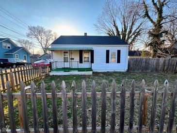 Charming one-story home featuring a covered porch and picket fence at 640 S Sycamore St, Martinsville, IN 46151