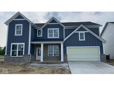 Charming two-story home with a blue exterior and a two-car garage with appealing architectural details at 6462 Stone Side Dr, Plainfield, IN 46168