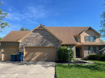 Charming two-story brick home featuring a spacious two-car garage and beautiful landscaping at 8400 Harrison Pkwy, Fishers, IN 46038