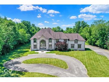 Stunning two-story home with a circular driveway and beautifully landscaped front yard at 11575 Freeport Dr, Carmel, IN 46032