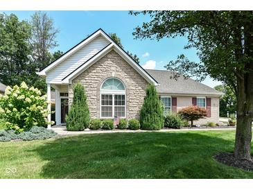 Charming stone home featuring a well-manicured lawn and established landscaping at 11692 Seven Oaks Dr, Fishers, IN 46038