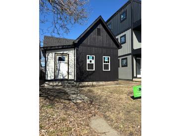 Modern black and white exterior of a newly built home with a simple, clean design and a well-maintained lawn at 1318 Hoyt Ave, Indianapolis, IN 46203