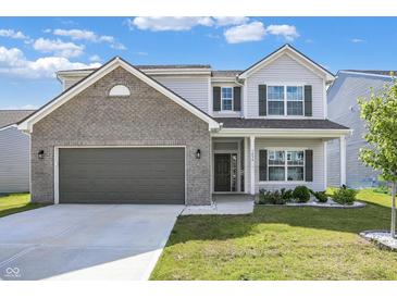 Charming two-story home with a well-manicured lawn, attached garage and a mix of brick and siding exterior at 1454 Silver Pine Ln, Sheridan, IN 46069