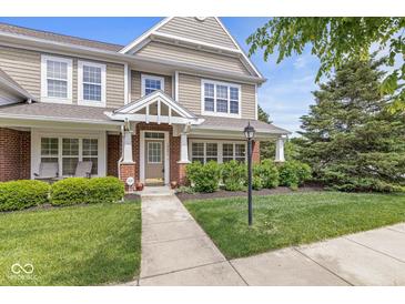 Charming two-story home with a well-manicured lawn and inviting front porch with brick and shake siding at 15421 Bowie Dr, Westfield, IN 46074