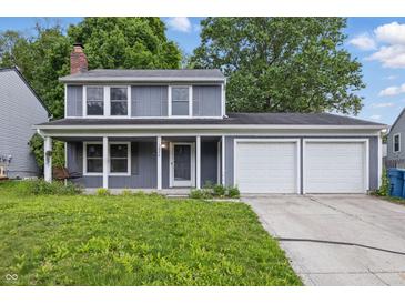 Charming two-story home with a three car garage and well-manicured front lawn at 1826 Shorter Dr, Indianapolis, IN 46214