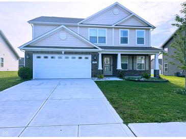 Beautiful two-story home with a brick-accented facade, well-manicured lawn and a large two car garage at 276 Rocky Rd, Greenfield, IN 46140