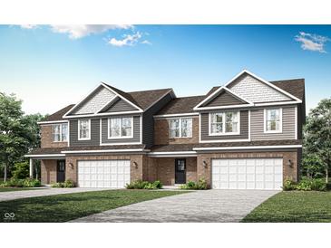 Charming new construction townhome featuring brick and siding with a two-car garage and beautiful landscaping at 2922 Woods Edge Dr, Greenwood, IN 46143