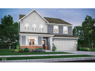 Charming two-story home showcasing a beautifully designed exterior with a two-car garage and a mix of textures and colors at 3104 Glasgow Pl, Danville, IN 46122